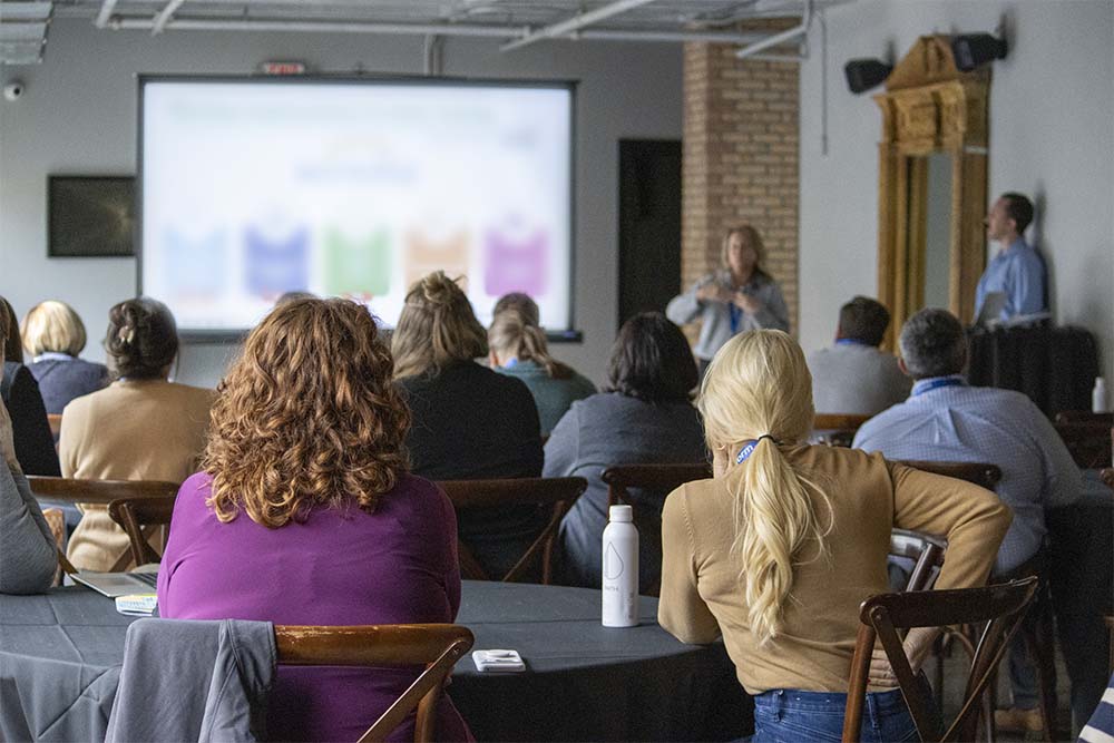 uPerForum attendees engaged with client-led presentation.